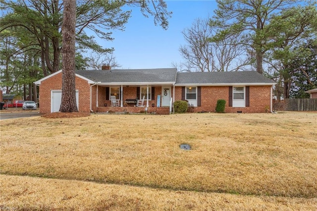 ranch-style home with brick siding, fence, a porch, and a front yard