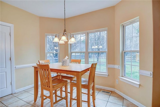 dining room with a chandelier, visible vents, baseboards, and light tile patterned floors