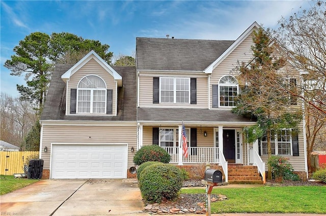 traditional-style house with an attached garage, covered porch, fence, driveway, and roof with shingles