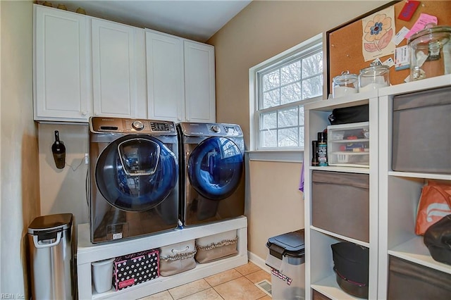 washroom featuring cabinet space, separate washer and dryer, and tile patterned floors