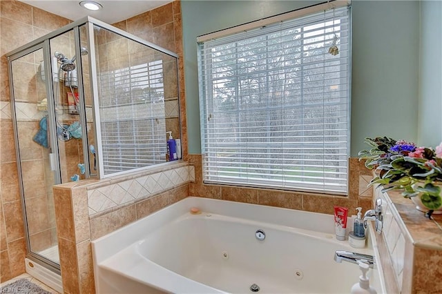 full bathroom with a stall shower and a tub with jets