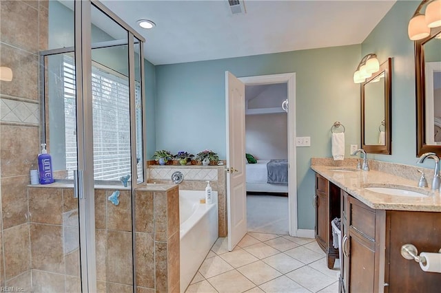 bathroom with a garden tub, tile patterned flooring, a sink, and visible vents