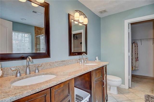 bathroom with tile patterned flooring, a sink, and visible vents