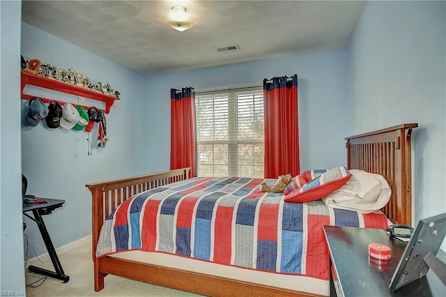 carpeted bedroom with visible vents and baseboards