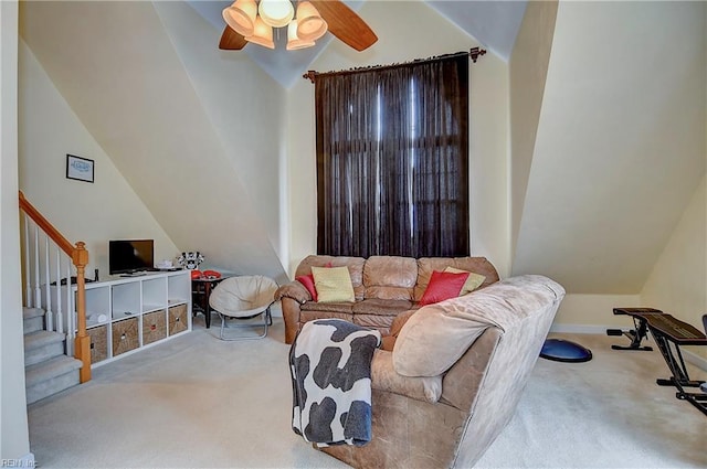 living room with a ceiling fan, lofted ceiling, carpet flooring, and stairs