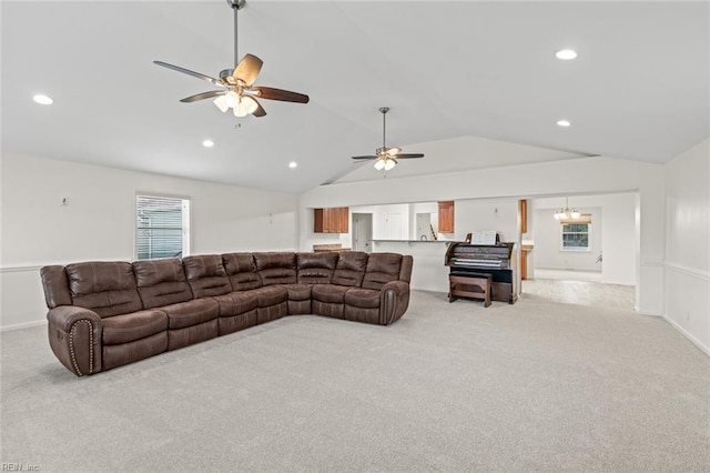 living room with light carpet, recessed lighting, ceiling fan with notable chandelier, and lofted ceiling