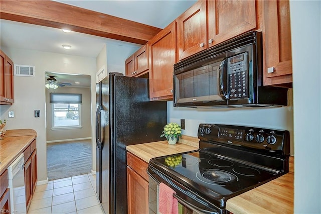 kitchen featuring visible vents, beamed ceiling, black appliances, wooden counters, and light tile patterned flooring