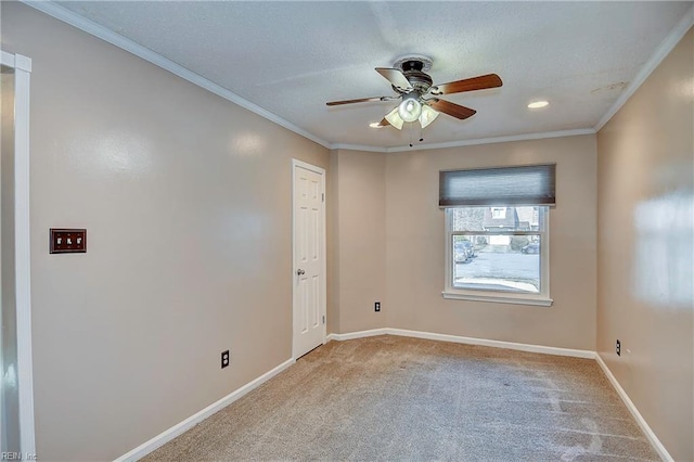 unfurnished room featuring ornamental molding, ceiling fan, carpet floors, and baseboards