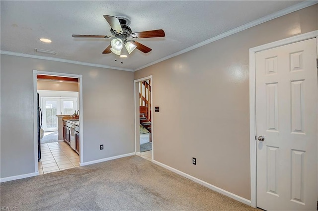 unfurnished bedroom featuring ornamental molding, light colored carpet, baseboards, and fridge