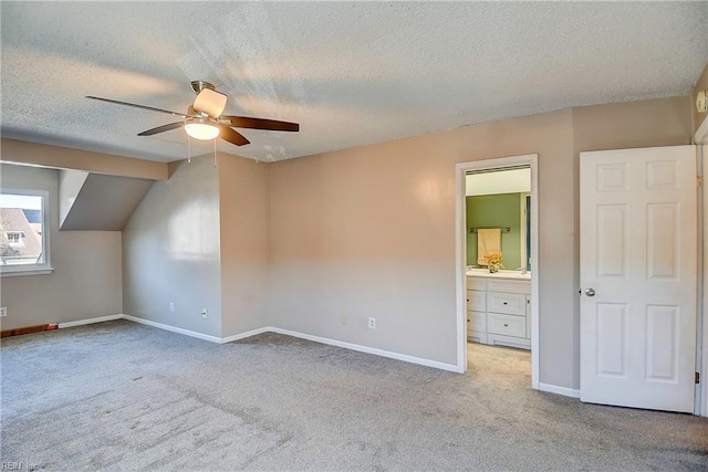 additional living space with carpet floors, a textured ceiling, and baseboards