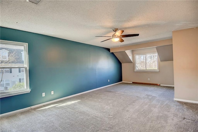 bonus room featuring visible vents, a ceiling fan, carpet flooring, a textured ceiling, and baseboards