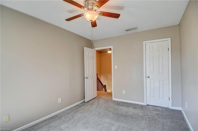 unfurnished bedroom featuring carpet floors, visible vents, and baseboards