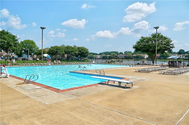 community pool featuring a patio area and fence