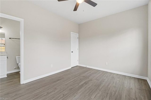 unfurnished bedroom with a ceiling fan, baseboards, and wood finished floors