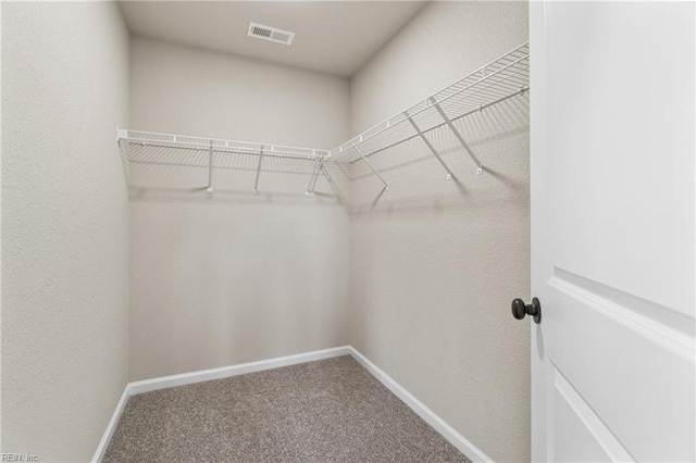 walk in closet featuring carpet and visible vents