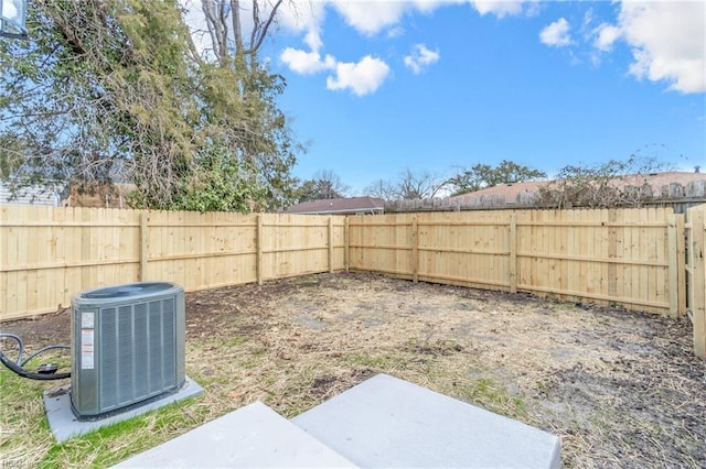 view of yard featuring a fenced backyard and central AC unit