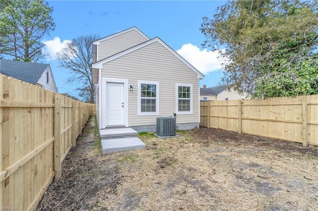 back of property featuring a fenced backyard and cooling unit