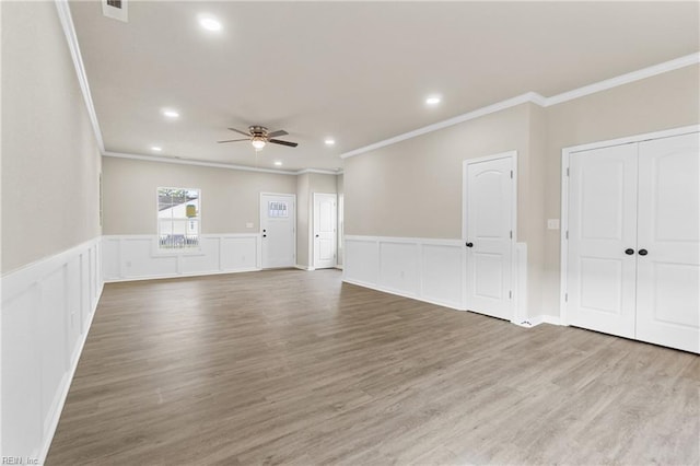 empty room with recessed lighting, visible vents, a ceiling fan, ornamental molding, and wood finished floors