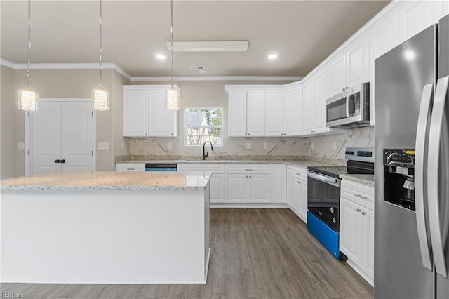 kitchen with appliances with stainless steel finishes, decorative backsplash, dark wood finished floors, and white cabinets