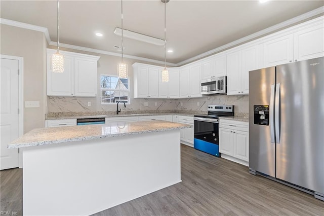 kitchen with a center island, stainless steel appliances, backsplash, dark wood-type flooring, and ornamental molding