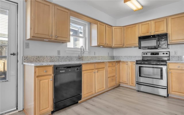 kitchen with light stone counters, light wood-style flooring, a sink, light brown cabinetry, and black appliances