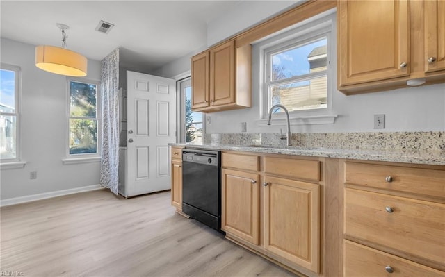 kitchen with plenty of natural light, black dishwasher, visible vents, and a sink