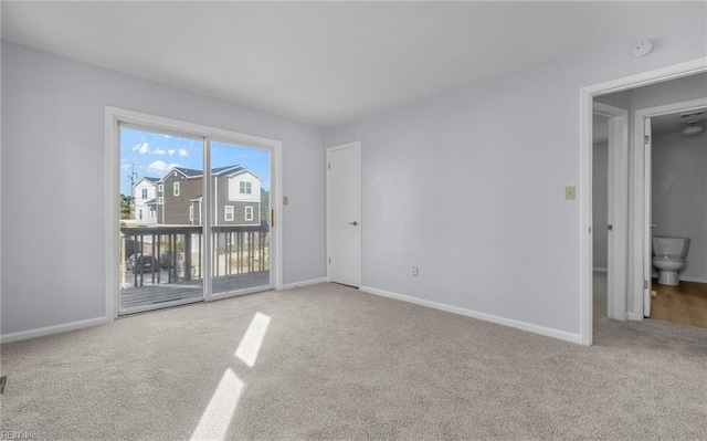 unfurnished room with carpet and baseboards