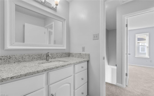 bathroom with baseboards and vanity