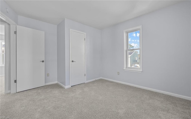 unfurnished bedroom featuring baseboards and carpet flooring