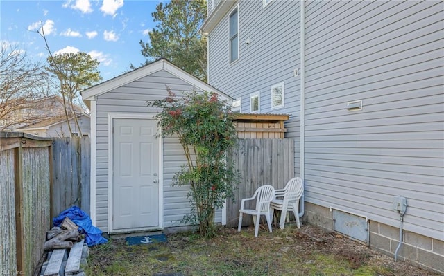 view of shed featuring fence