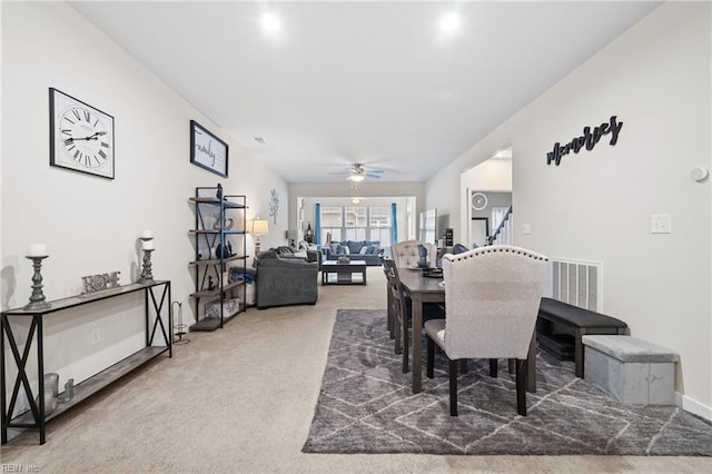 dining area featuring carpet floors and ceiling fan