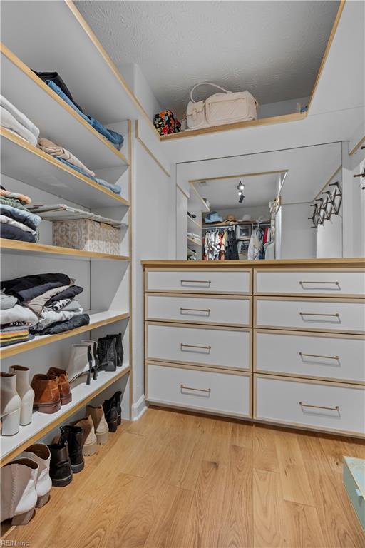 spacious closet featuring light wood-type flooring