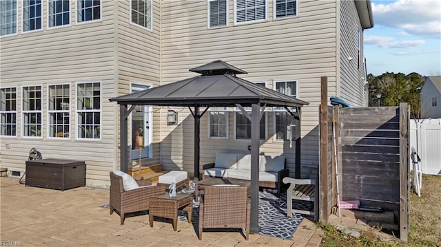 exterior space featuring entry steps, fence, an outdoor hangout area, and a gazebo