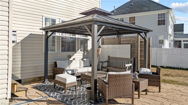 view of patio featuring a gazebo, fence, and an outdoor living space