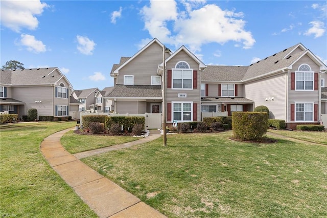 view of front of home featuring a residential view and a front lawn