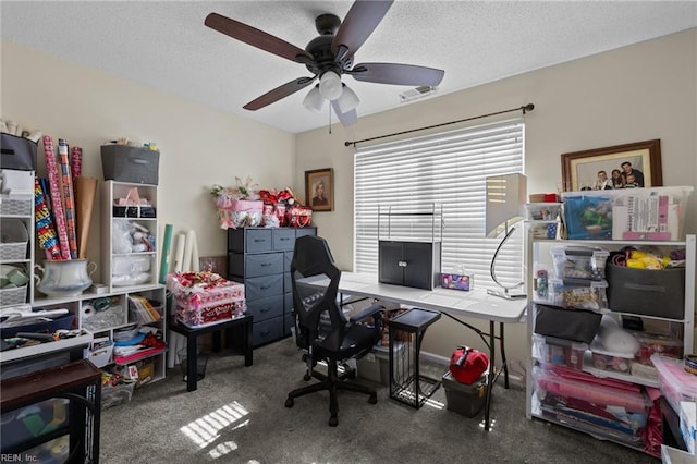 office space with ceiling fan, carpet flooring, and a textured ceiling