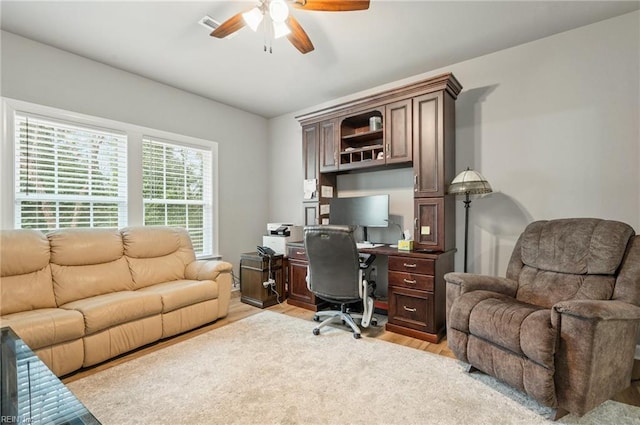 office space with light wood-style floors and a ceiling fan