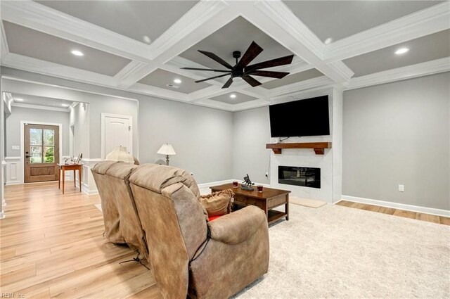 living area featuring a fireplace, coffered ceiling, and beam ceiling