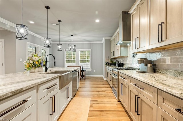 kitchen featuring decorative backsplash, wall chimney exhaust hood, stainless steel appliances, crown molding, and light wood-style floors