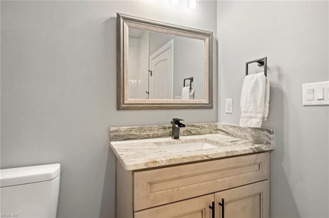 half bath with vanity and toilet
