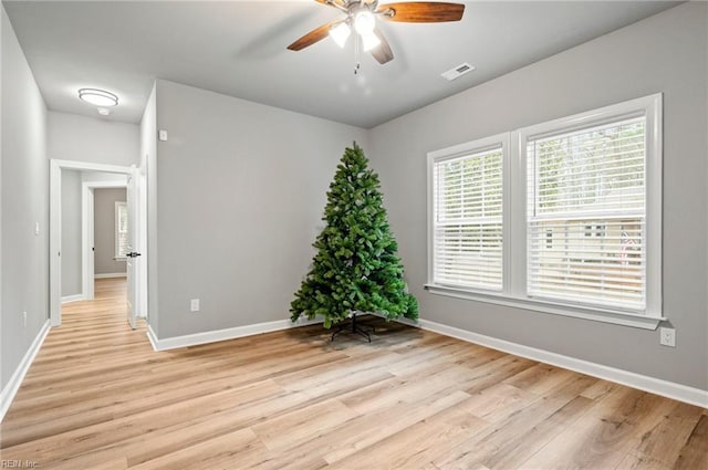 unfurnished room with light wood-type flooring, baseboards, and visible vents