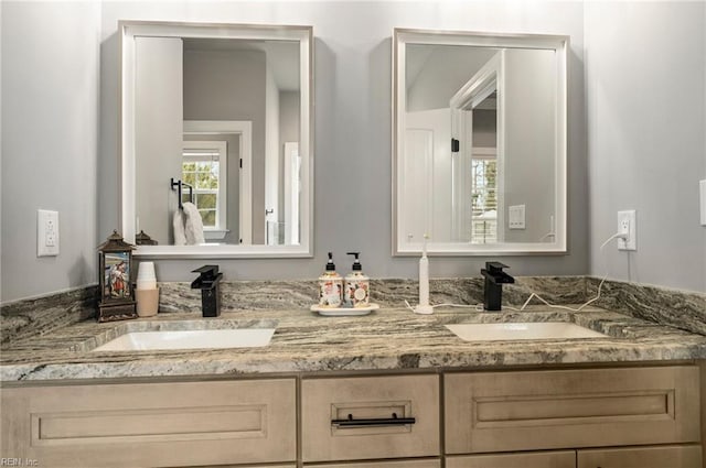 bathroom with a sink and double vanity