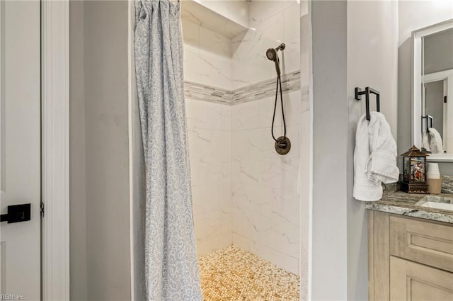 full bathroom featuring a shower stall and vanity