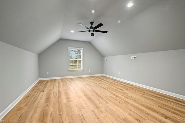bonus room with visible vents, baseboards, lofted ceiling, ceiling fan, and light wood-type flooring