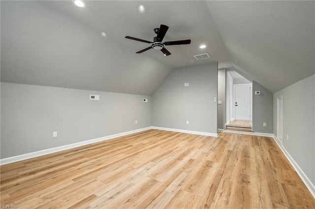 bonus room featuring vaulted ceiling, baseboards, visible vents, and light wood-style floors