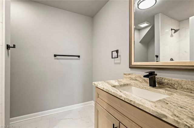 full bathroom featuring marble finish floor, walk in shower, vanity, and baseboards