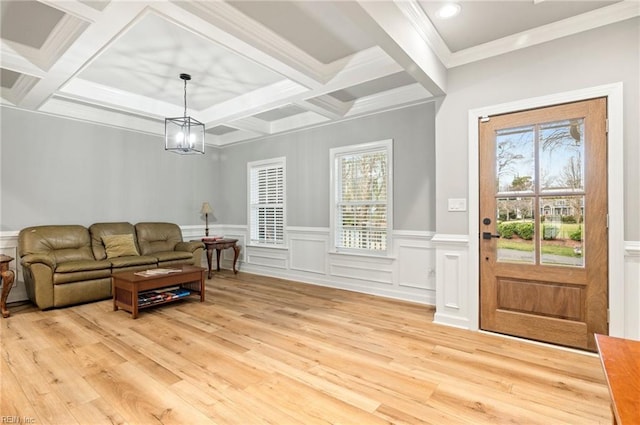 living area featuring light wood finished floors, a notable chandelier, coffered ceiling, and beam ceiling
