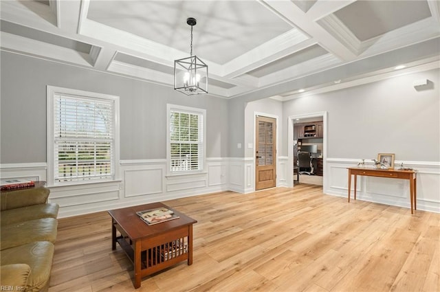 living area with coffered ceiling, wainscoting, an inviting chandelier, light wood-style floors, and beam ceiling