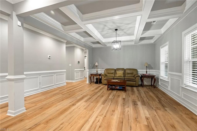 sitting room with light wood-type flooring, decorative columns, coffered ceiling, and beamed ceiling
