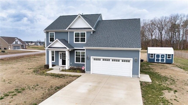 traditional home featuring a storage shed, driveway, a shingled roof, and an attached garage